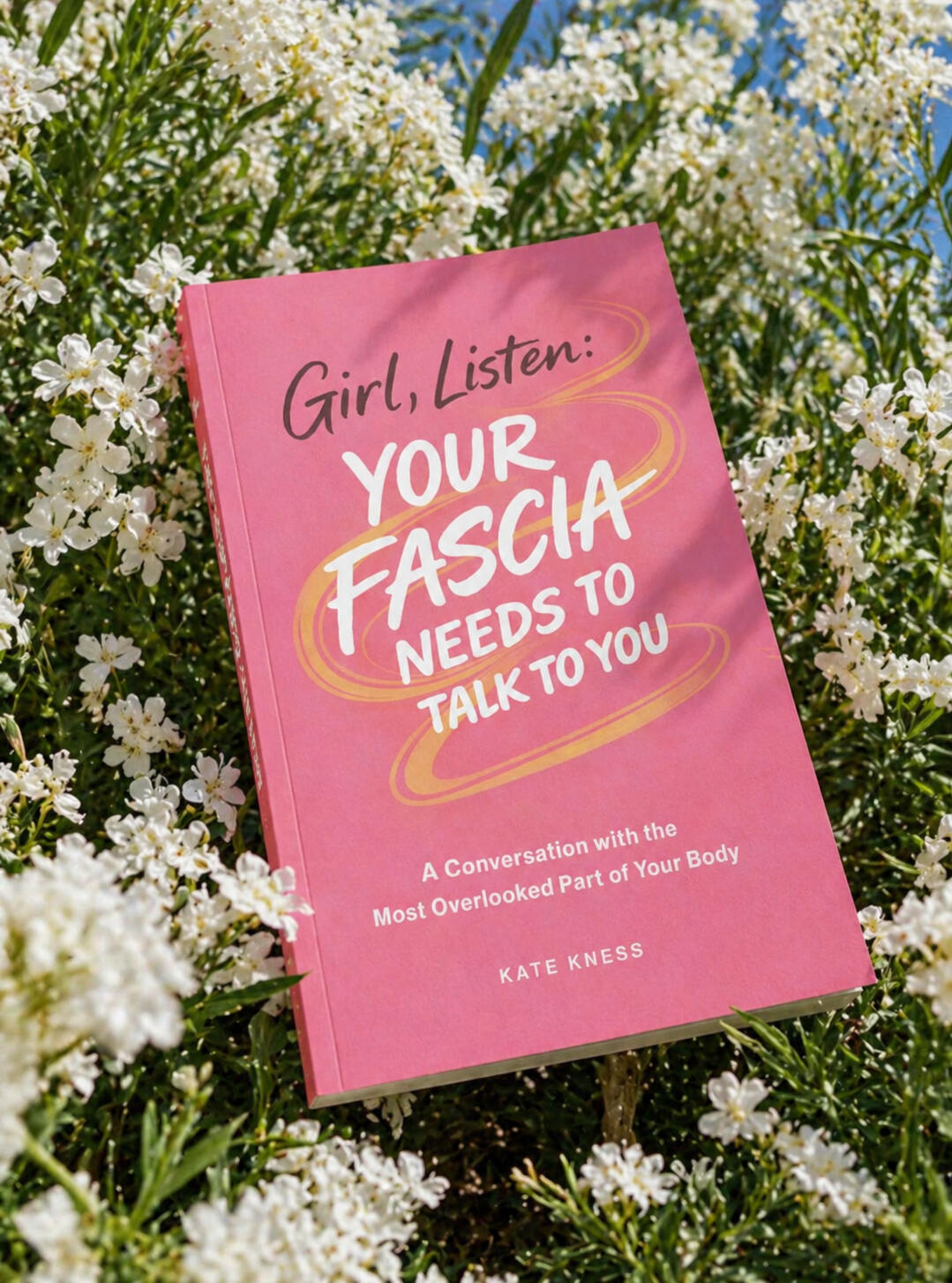 Book cover of Girl, Listen: Your Fascia Needs to Talk to You by Kate Kness, a fascia and body awareness book, styled in white flowers outdoors